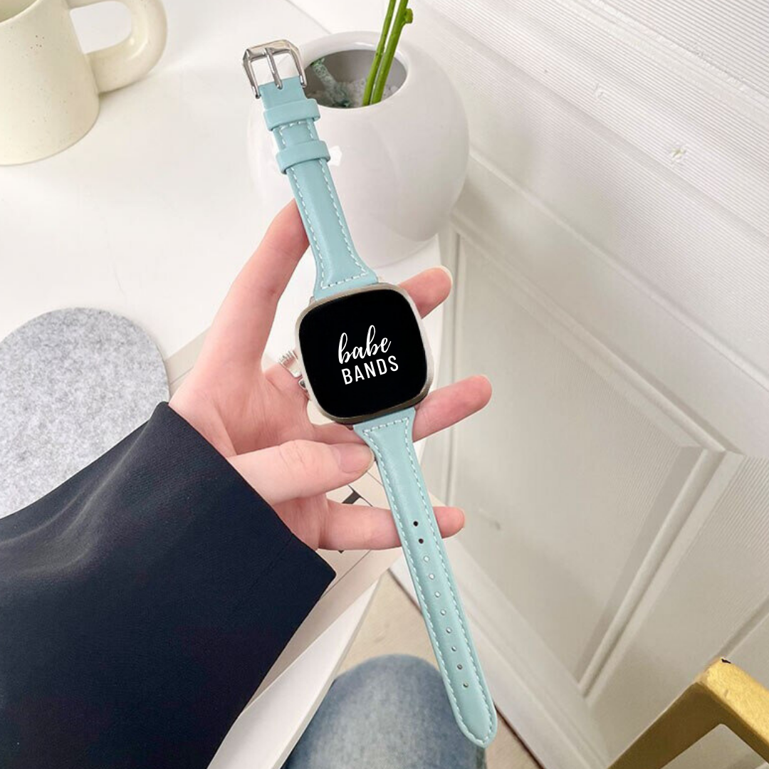 No more basic vibes. Step up your babe game with our premium Babe Bands to elevate your style.    Upgrade your Fitbit Versa or Fitbit Sense with our Premium Genuine Leather Slim Fitbit Versa/Sense Watch Band.  Indulge in the luxury look and feel of our Fitbit band, crafted from high-quality genuine leather with a stainless steel classic buckle closure.